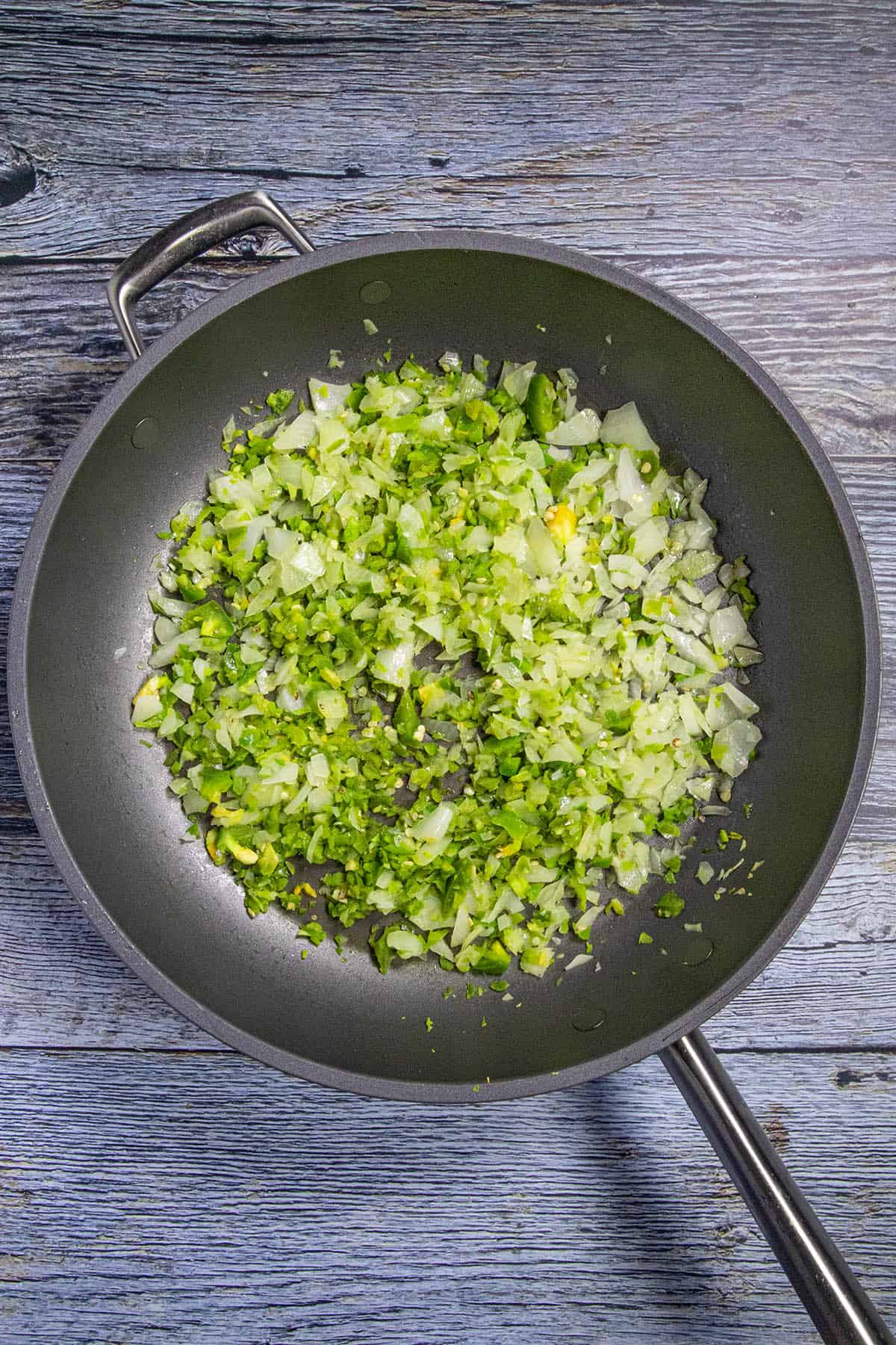 A pan of peppers and onions simmering to make Sloppy Joes