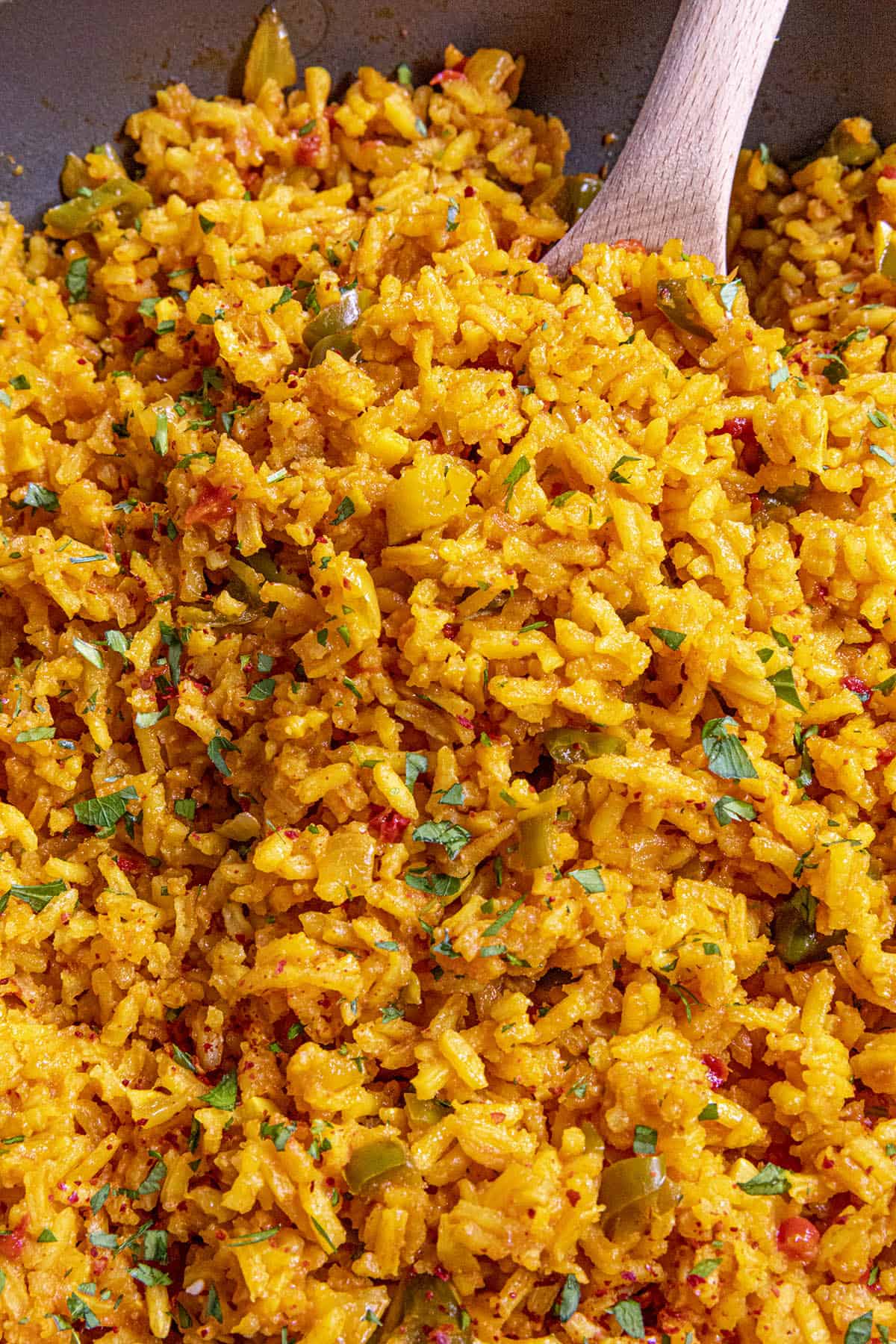 Mike scooping a spoonful of Yellow Rice from the pan