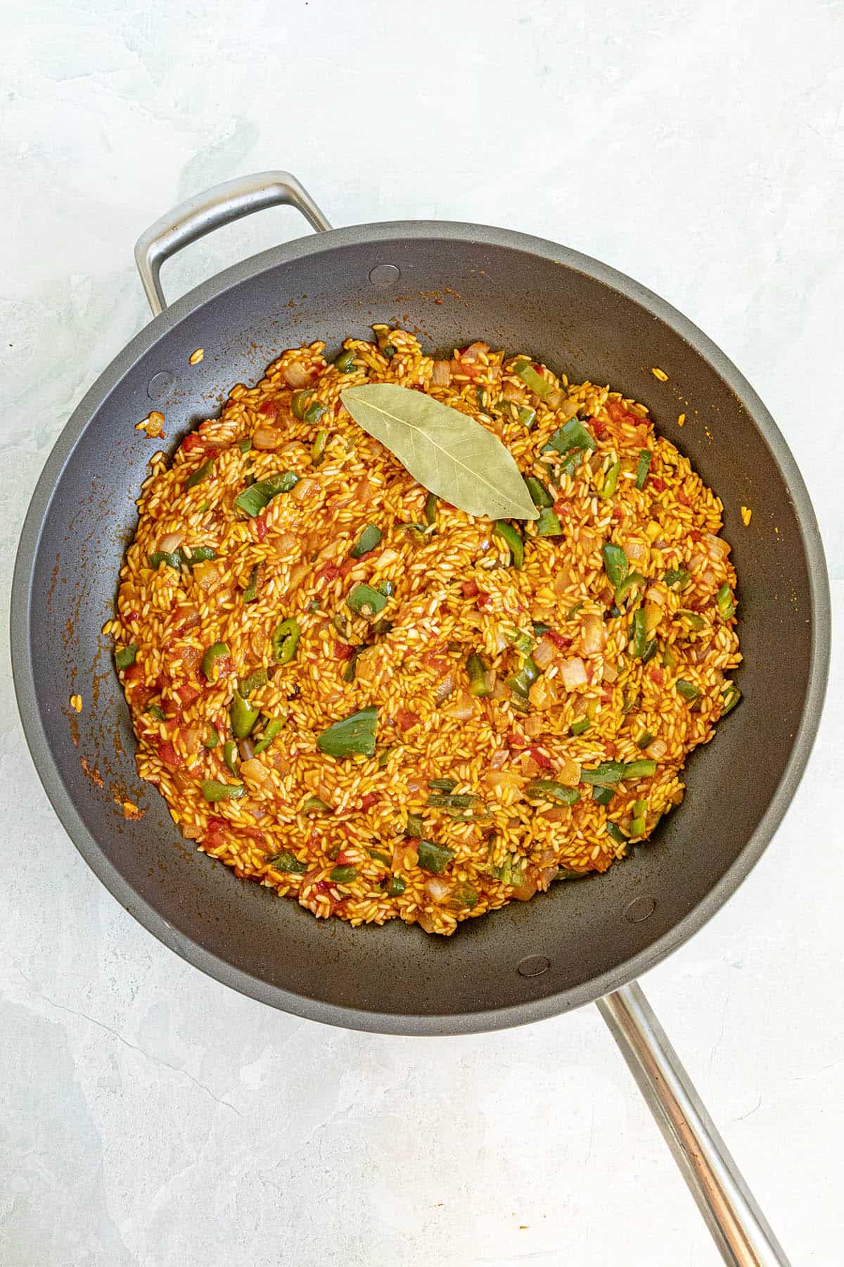 Tomato and spices added to the toasted rice to make Yellow Rice