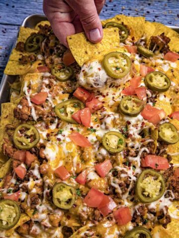 Mike taking a nacho from the pan