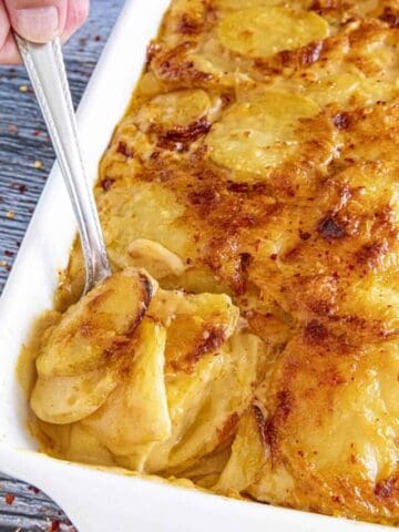 Mike serving cheesy Scalloped Potatoes