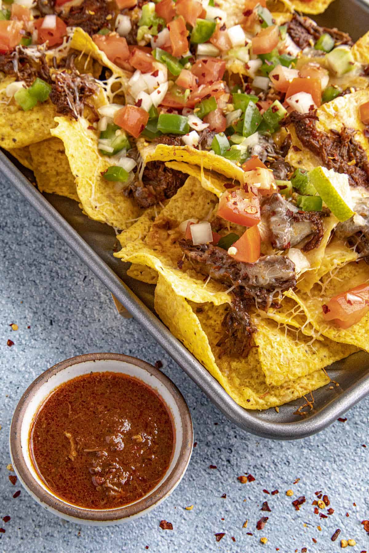 Birria consome in a bowl for dipping Birria Nachos