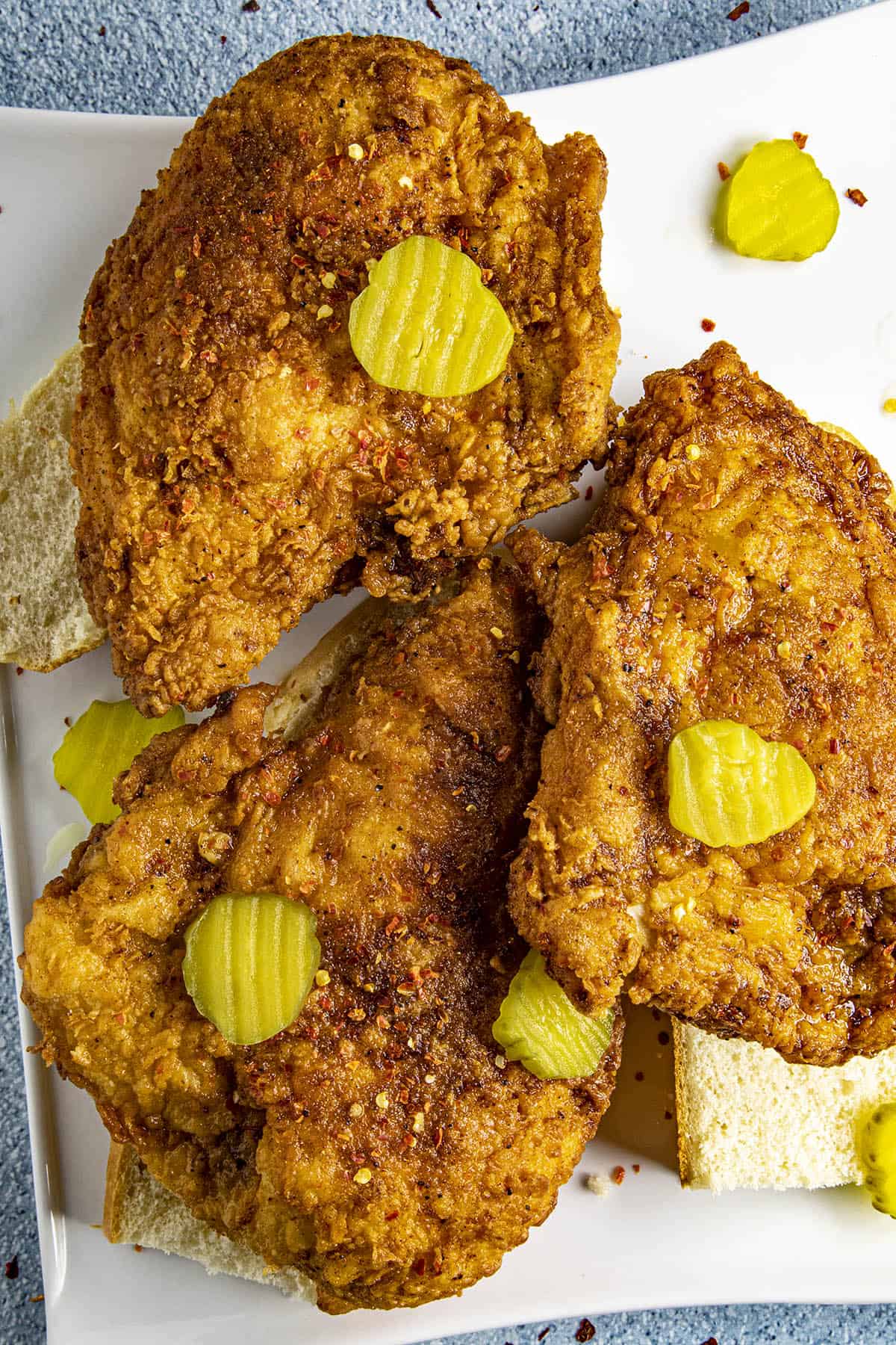 Nashville Hot Chicken on a serving platter, topped with sweet pickles