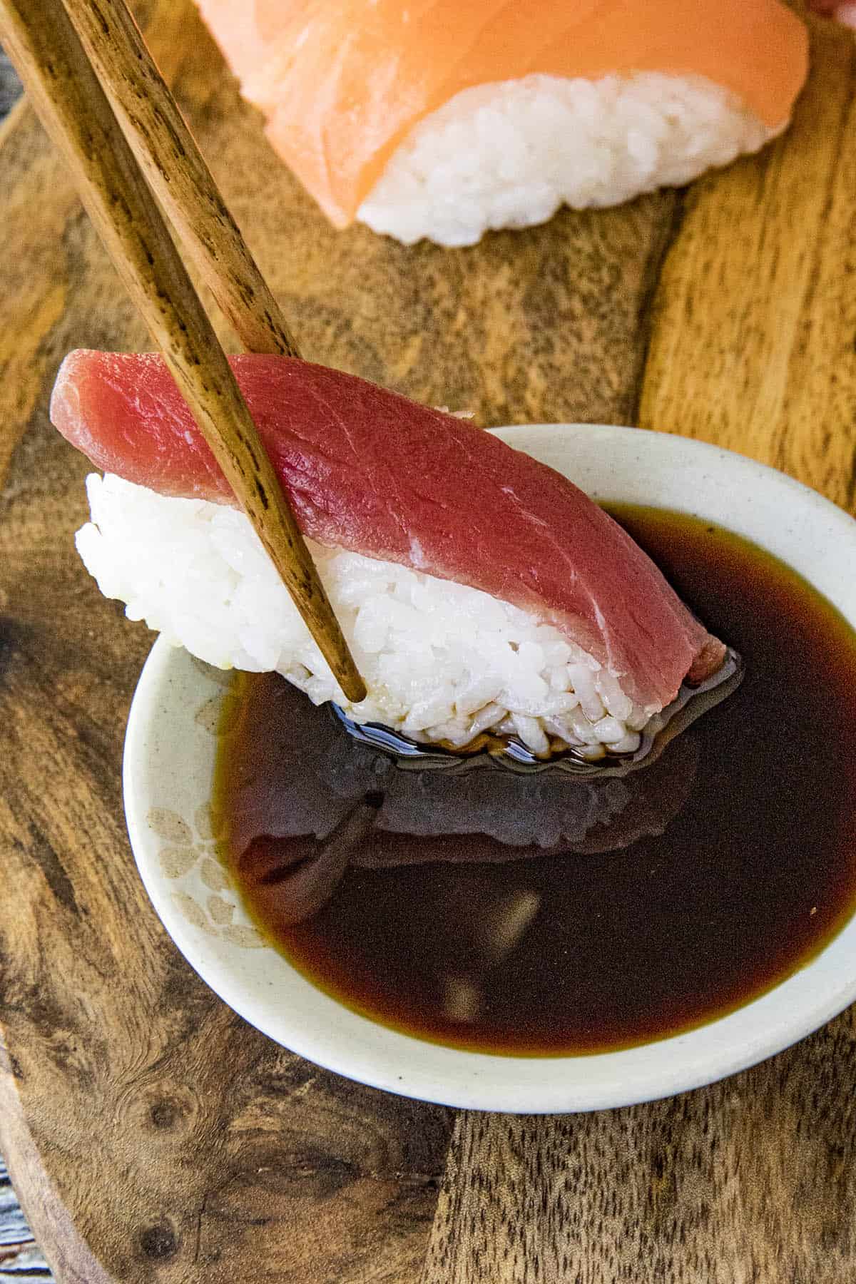 Dipping tuna sushi into a bowl of Ponzu Sauce