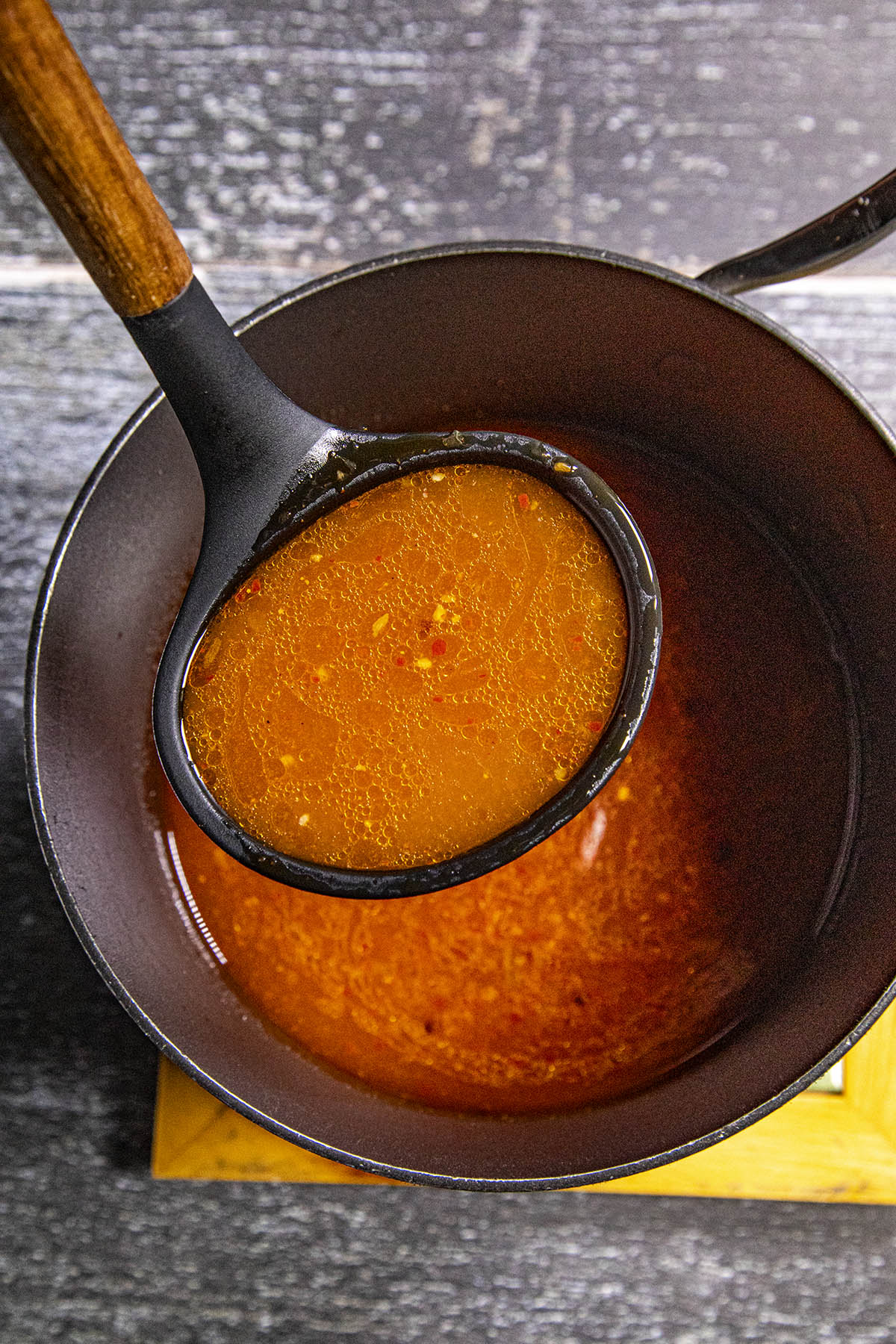 Homemade Buldak Ramen broth on a ladel