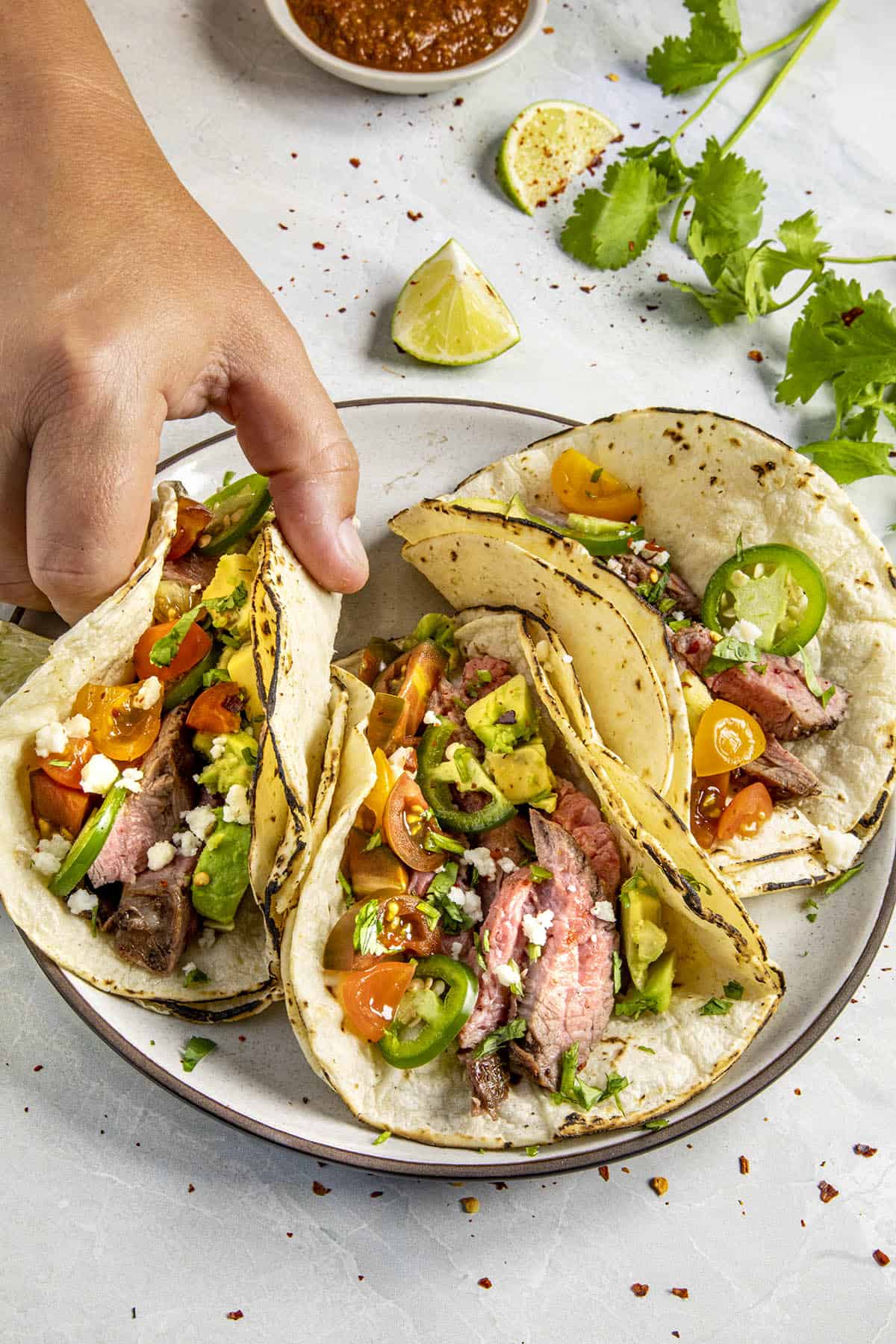 Mike taking a Carne Asada Taco from the plate