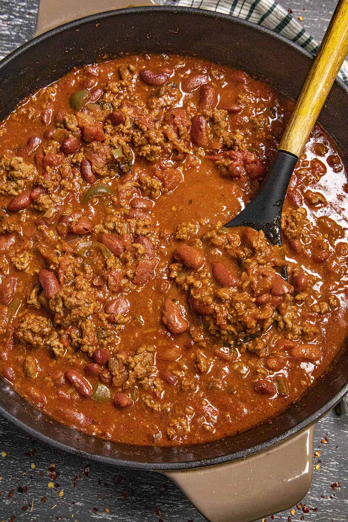 Stirring a big pot of classic homemade chili