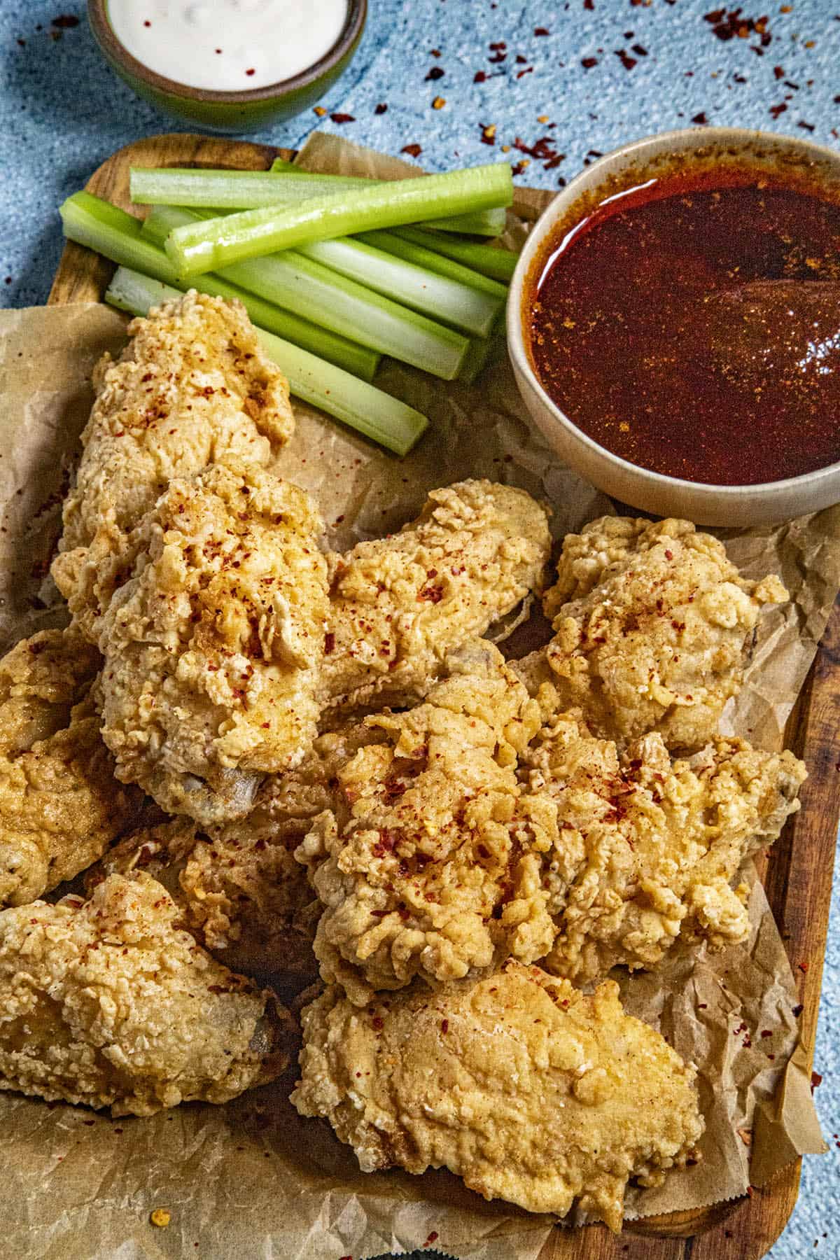 Fried Chicken Wings on a platter with sauce on the side