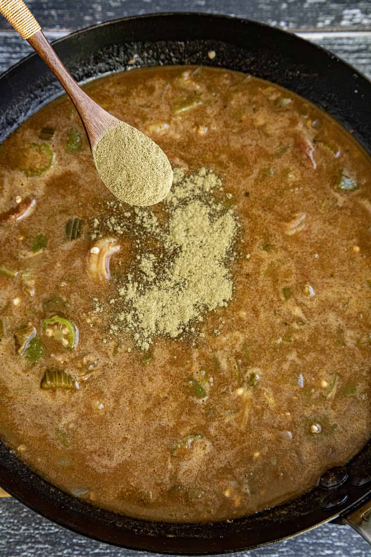 Gumbo File Powder being sprinkled into a pot of gumbo