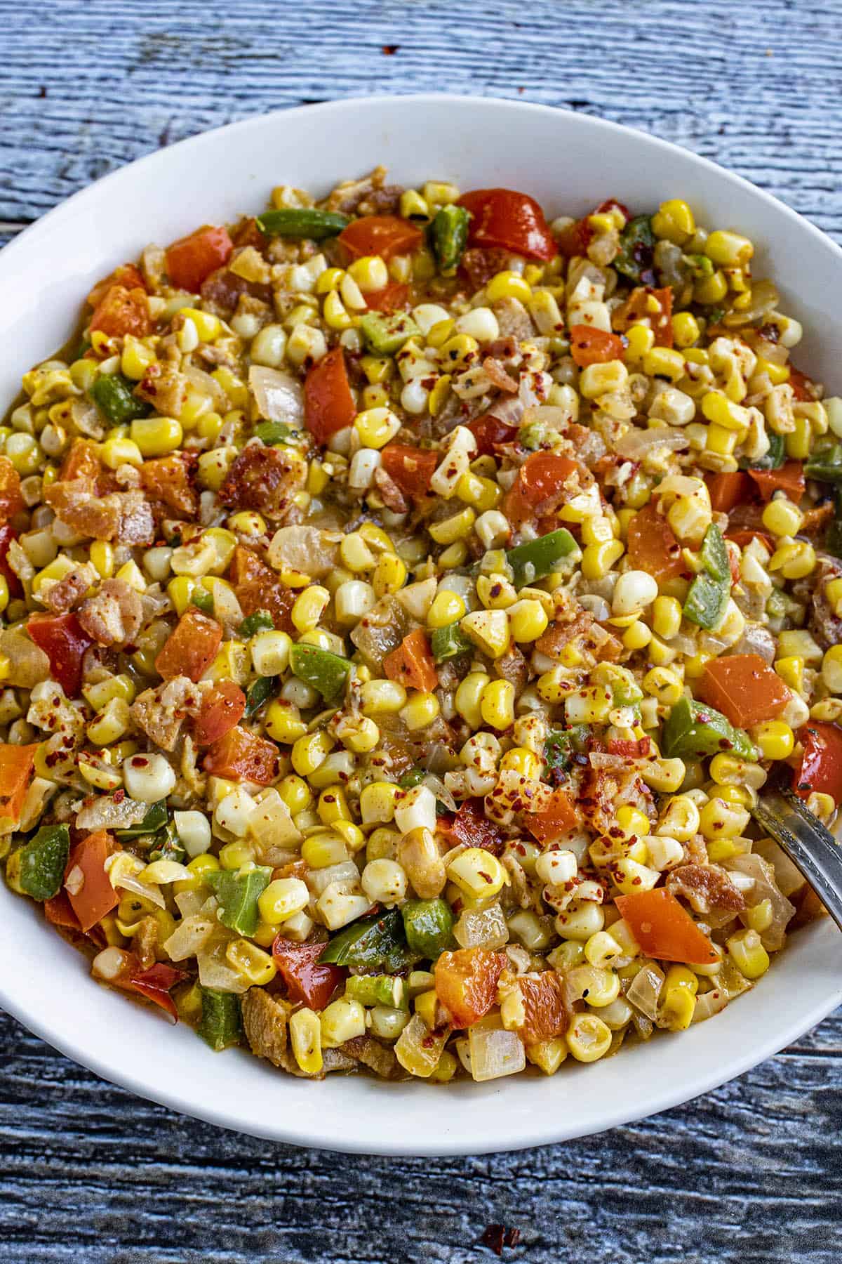 A serving bowl filled with Cajun Corn Maque Choux