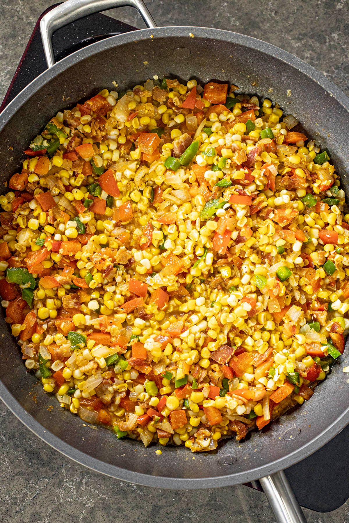 A simmering pan of Cajun Stewed Corn, aka Maque Choux