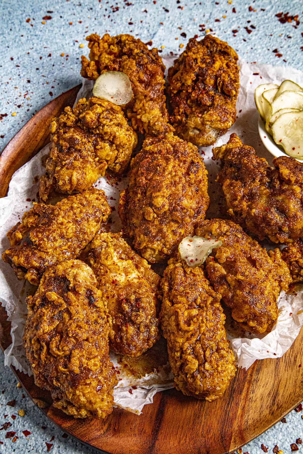 Fiery Nashville Hot Chicken Wings on a platter with sweet pickles
