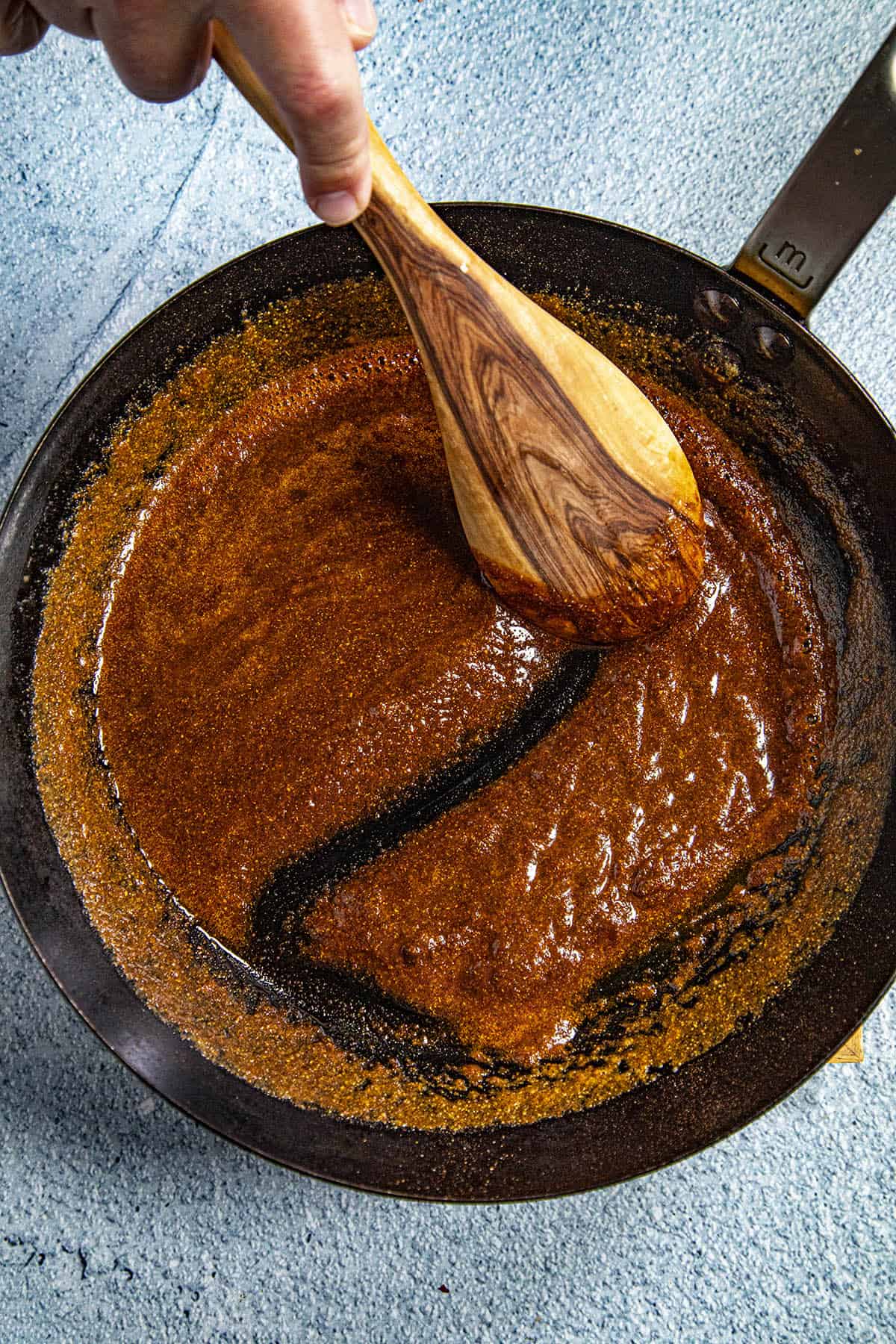 Mixing thick Nashville Hot Sauce in a pan