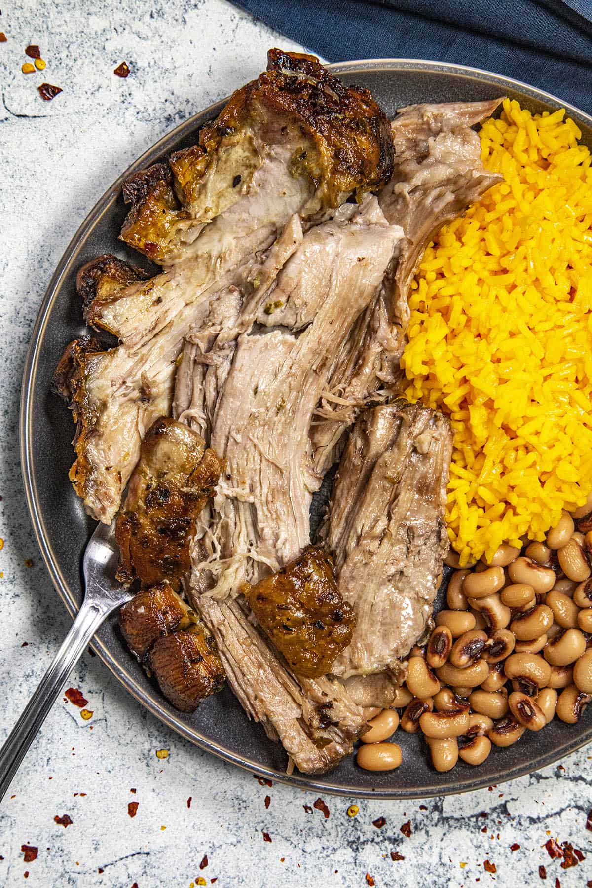 Puerto Rican Roast Pork (aka Pernil) served with rice and beans