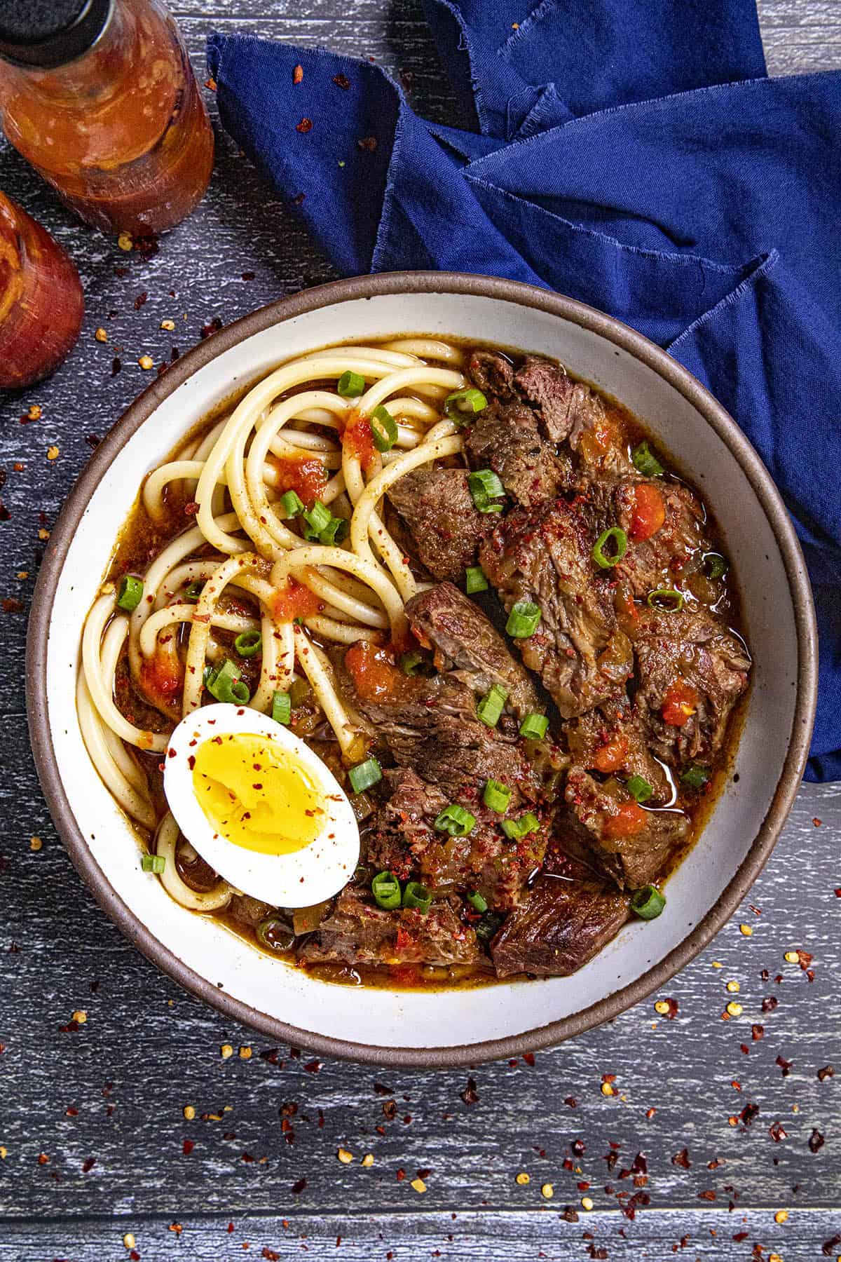 Creole Beef Noodle Soup, yakamein, in a bowl with hard boiled egg