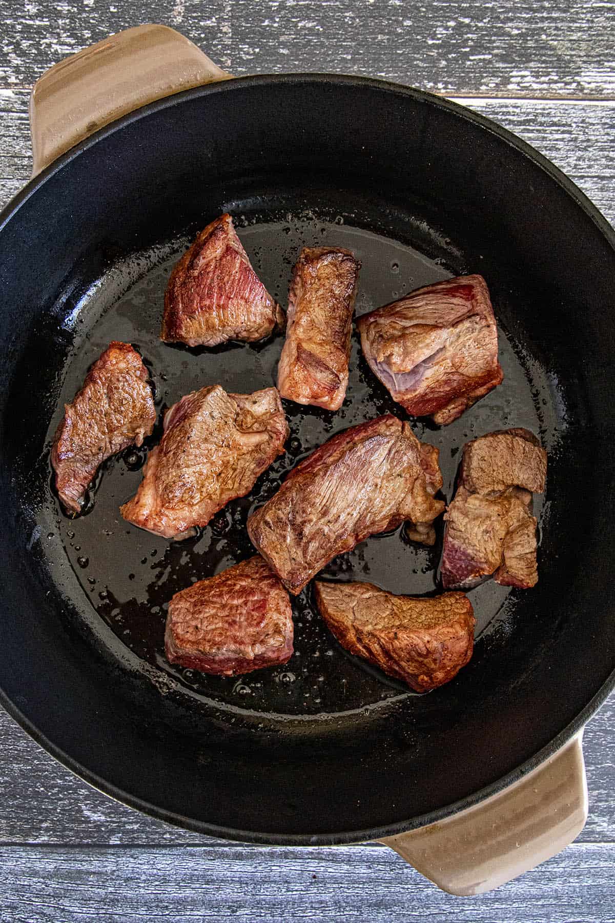 Searing the beef in a pot to make Yakamein