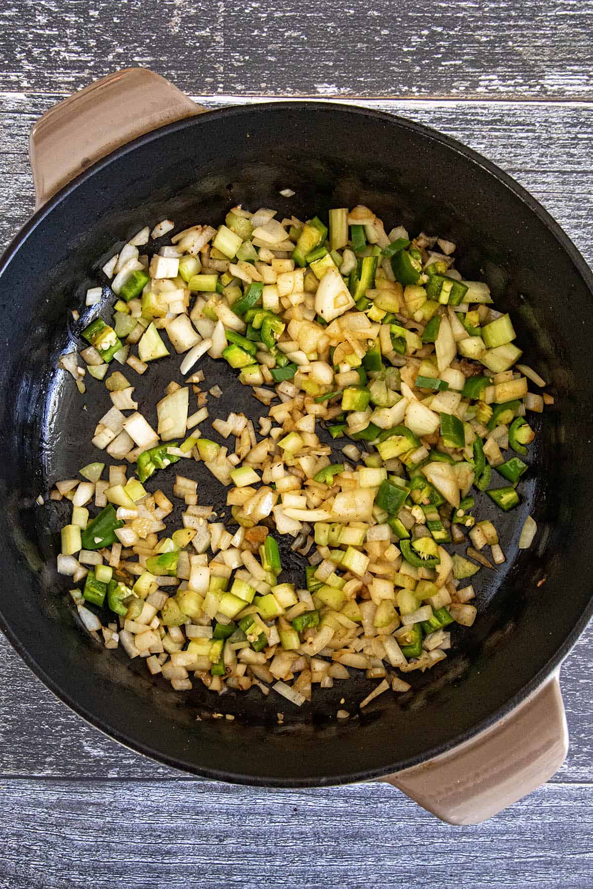 Cooking down vegetables in a pot to make Yakamein