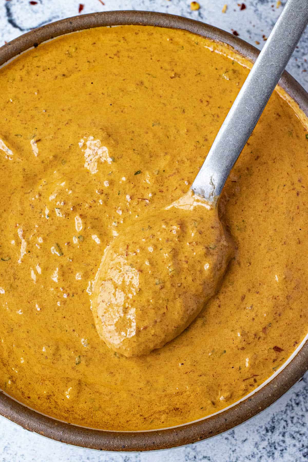 Scooping creamy Chipotle Sauce
