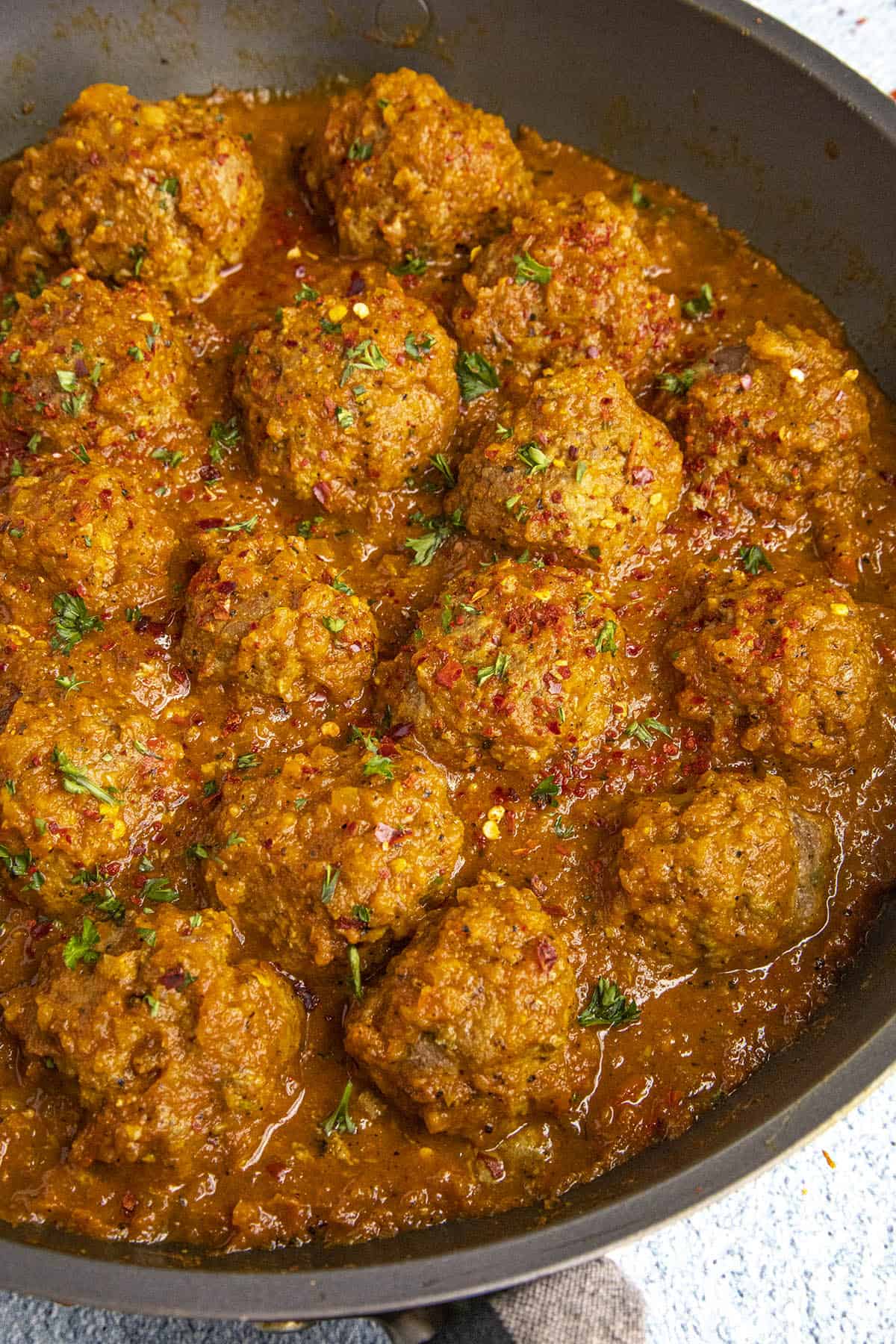 Curried Meatballs simmering in a pan