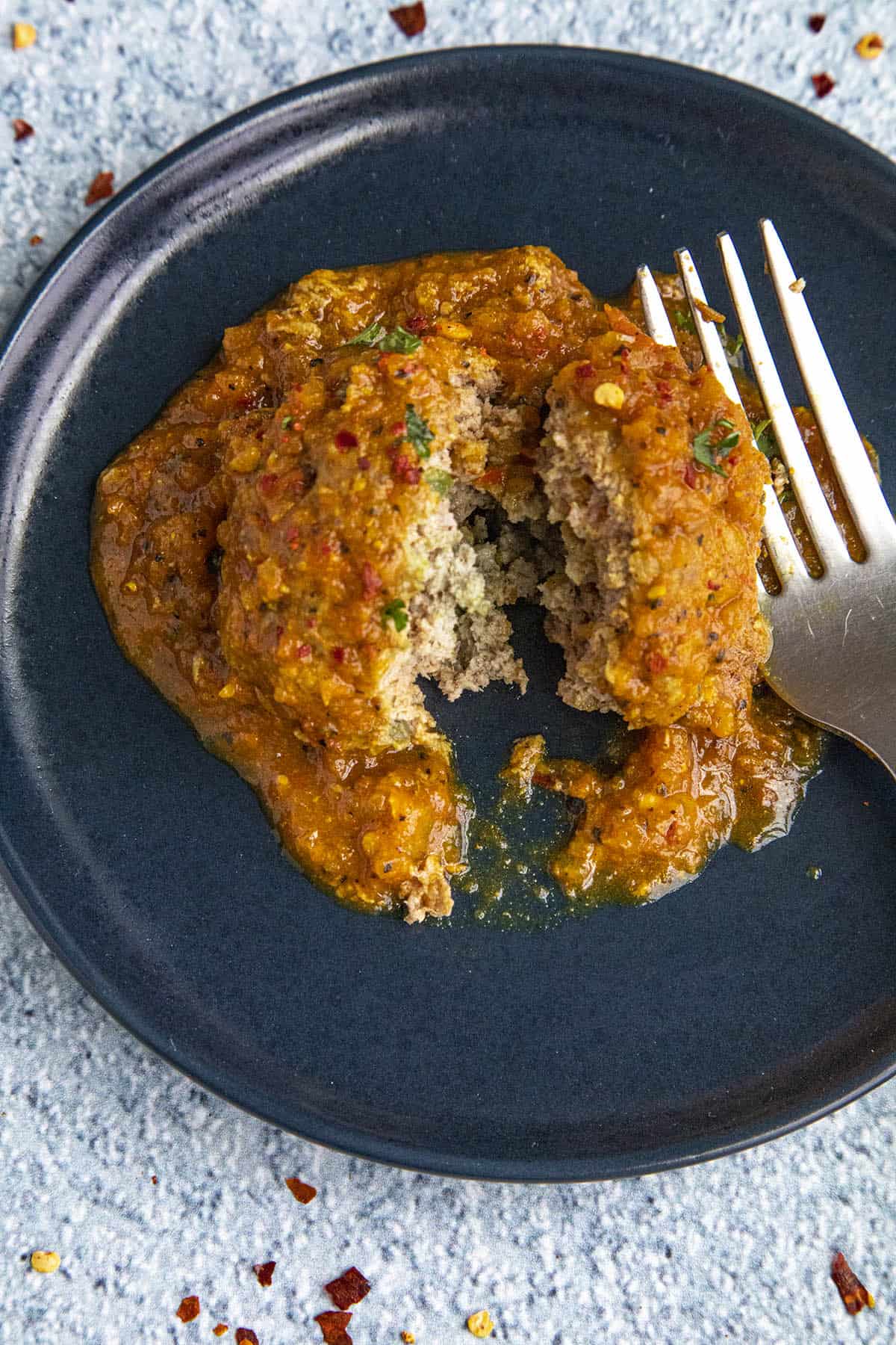 Mike using a fork to break into a tender Curried Meatball