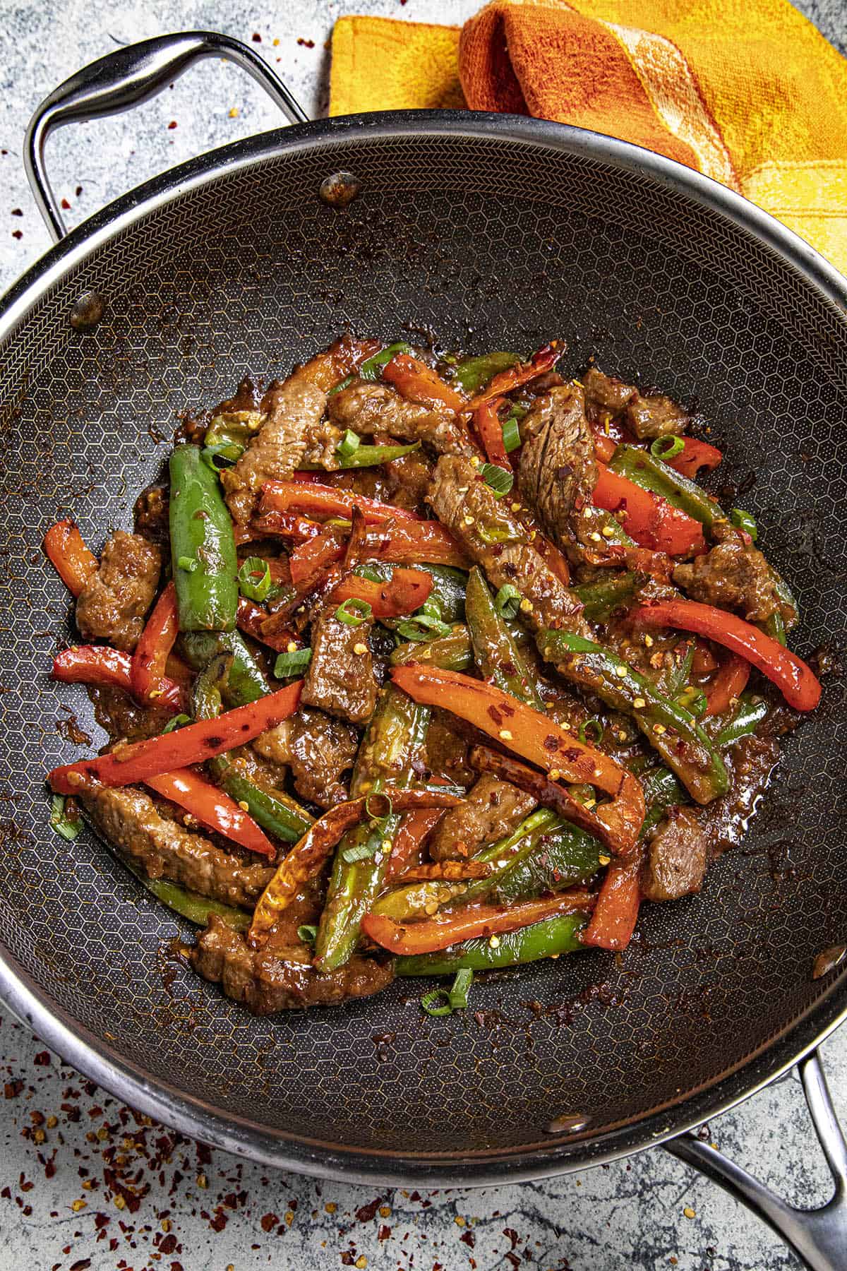 Hunan Beef in a wok with garnish