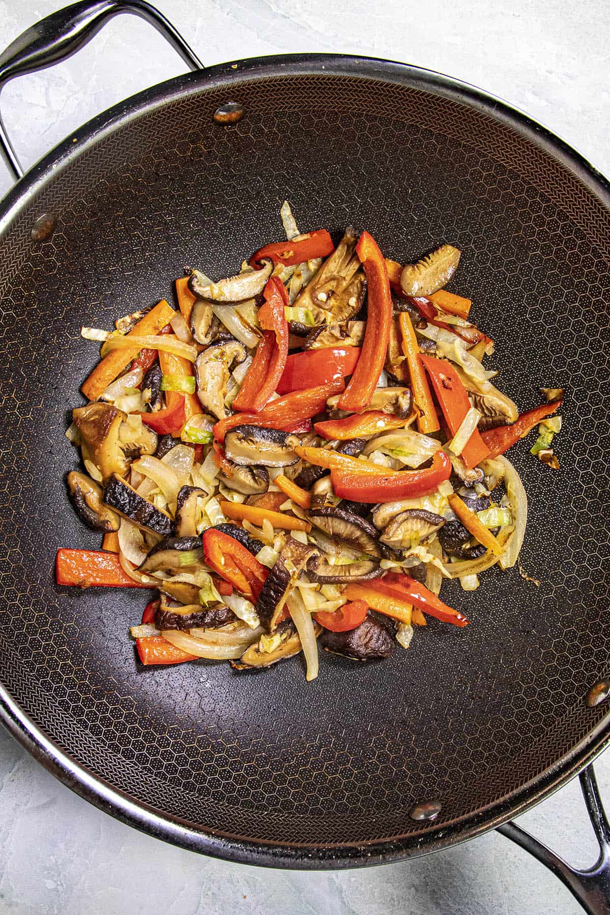 Stir frying vegetables in a wok to make Yaki Udon