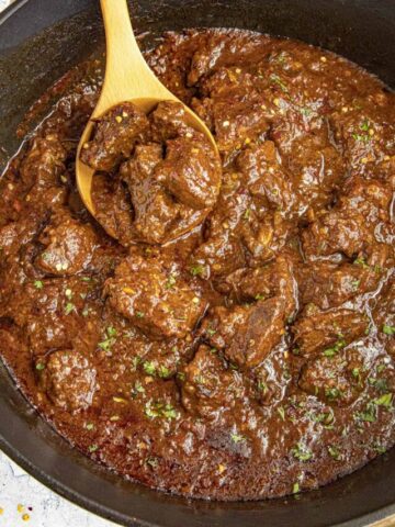 Serving chunky Chili Colorado from the simmering pot