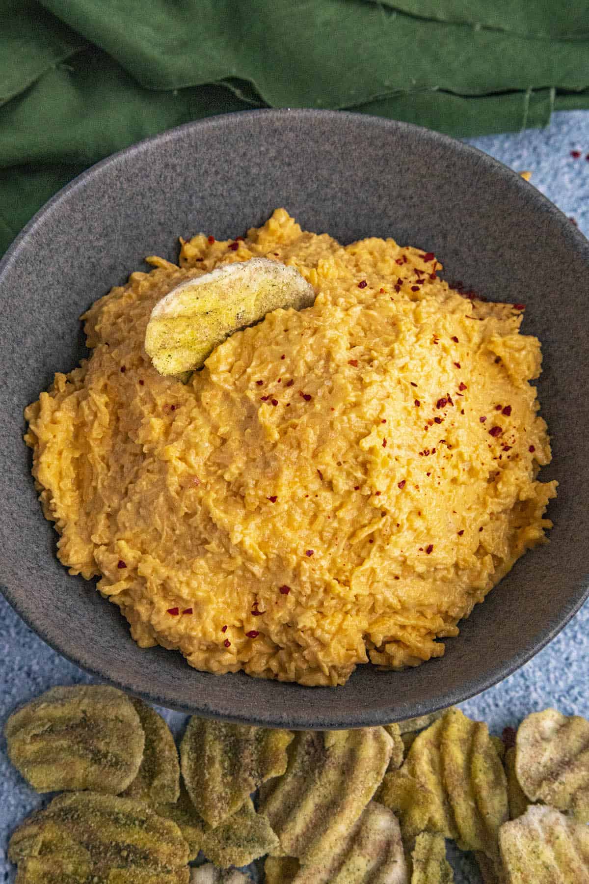 Aji Pimento Cheese Dip in a bowl with plantain chips