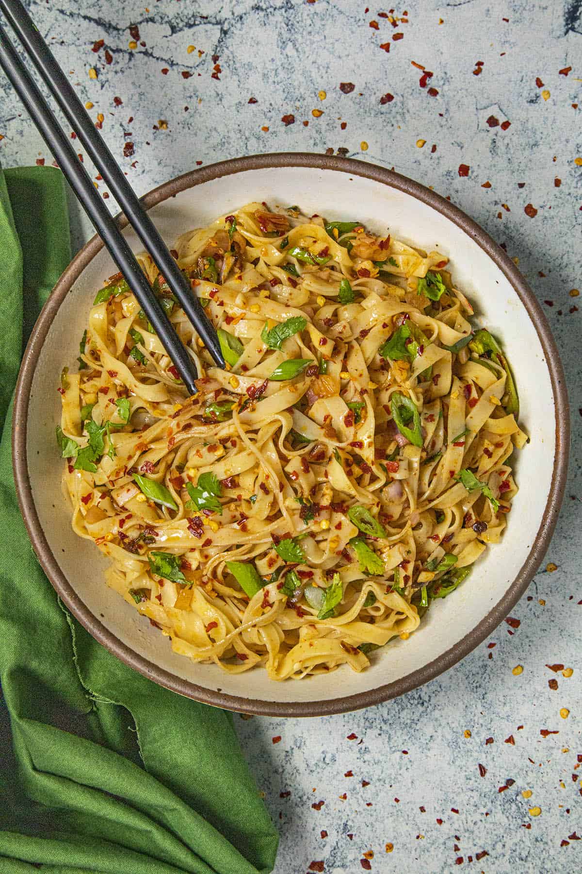 Spicy chili oil noodles in bowl with chopsticks