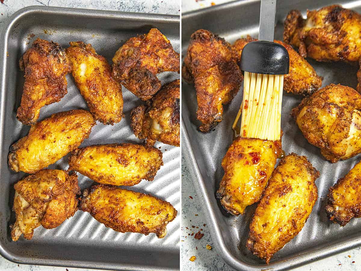 Brushing crispy cooked chicken wings with hot honey