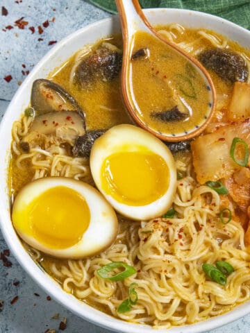 Kimchi Ramen noodles in a bowl with jammy ramen eggs