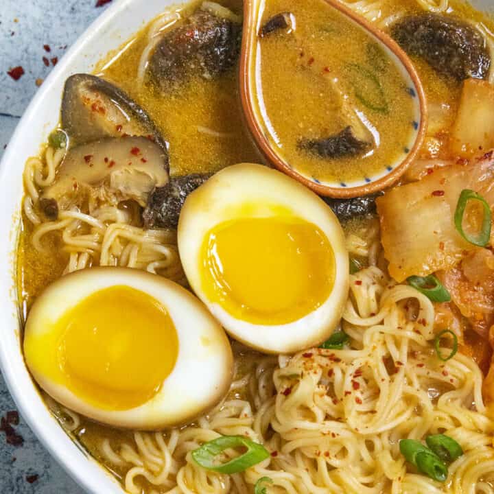 Kimchi Ramen noodles in a bowl with jammy ramen eggs