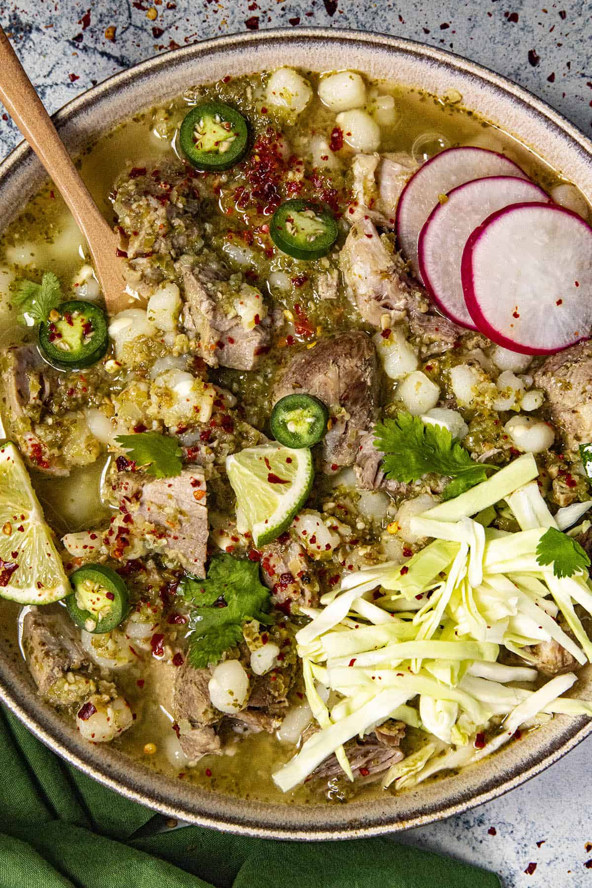 Pozole Verde in a bowl with garnish