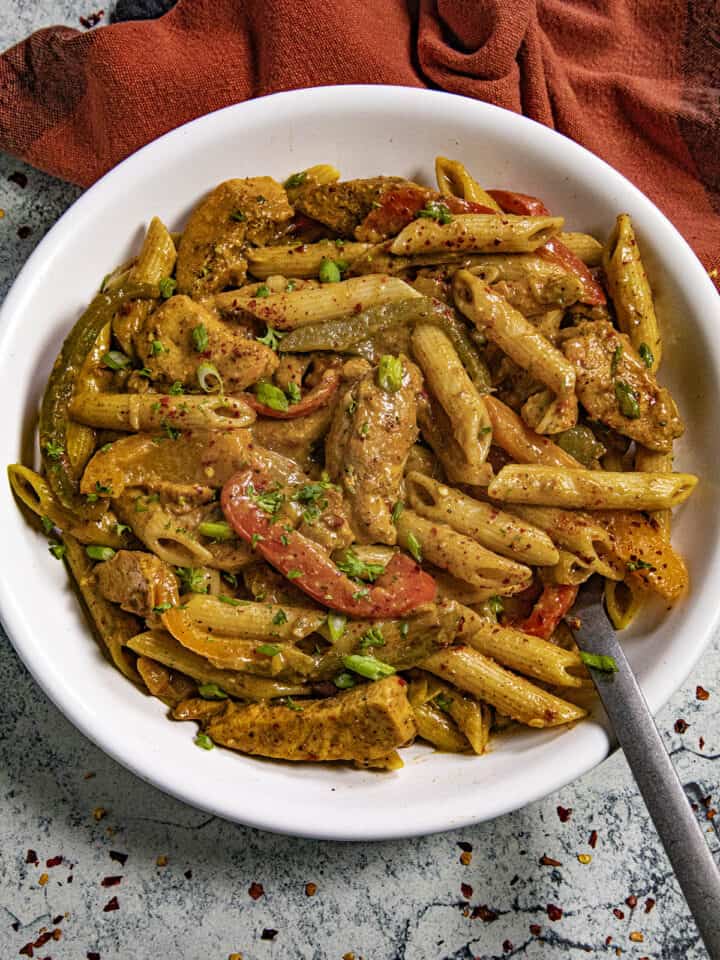 Rasta Pasta in a bowl with jerk chicken