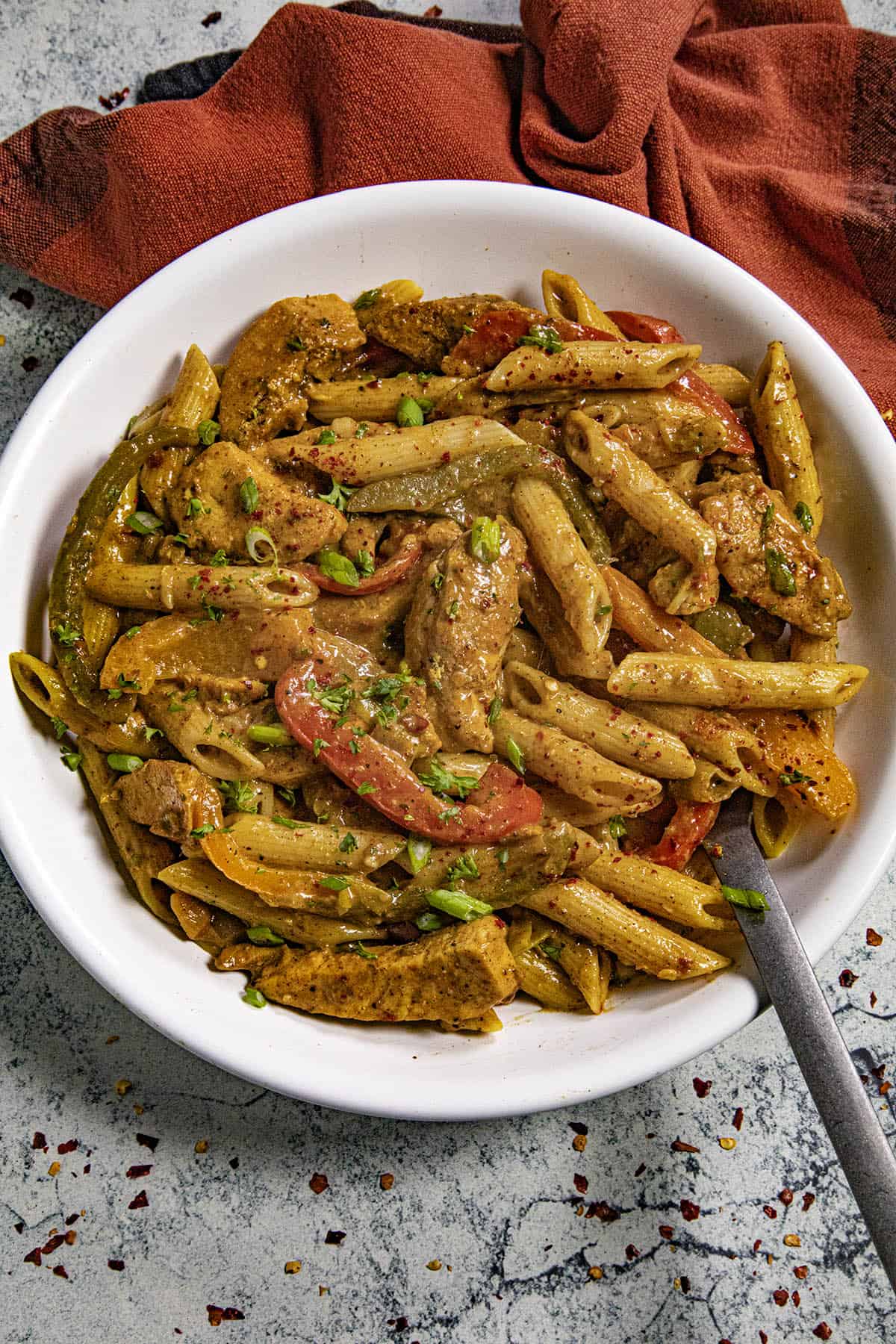 Rasta Pasta in a bowl with jerk chicken