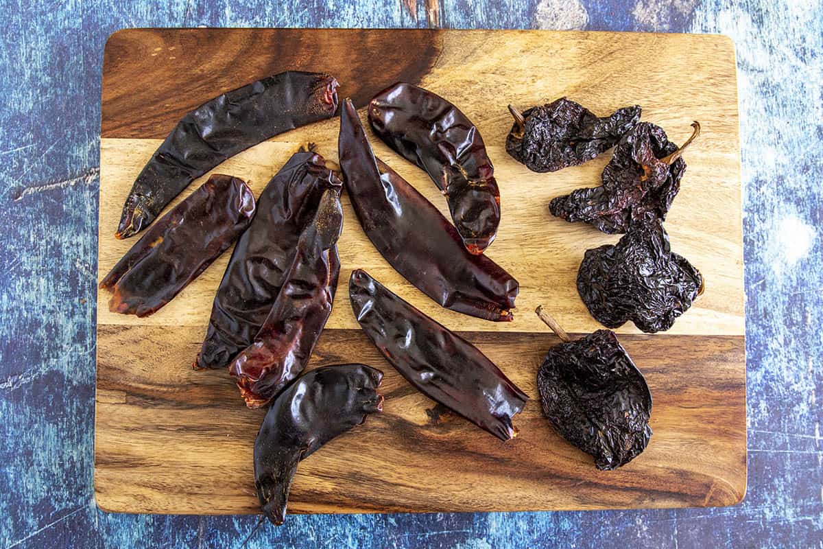 Ancho chilies and guajillo chilies on a platter for making Mexican adobo sauce