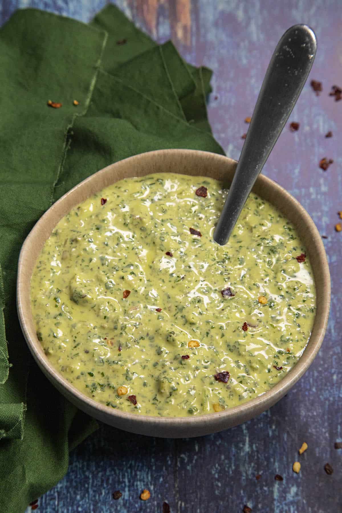 Creamy Peruvian Aji Verde Sauce in a bowl with a spoon, ready to serve