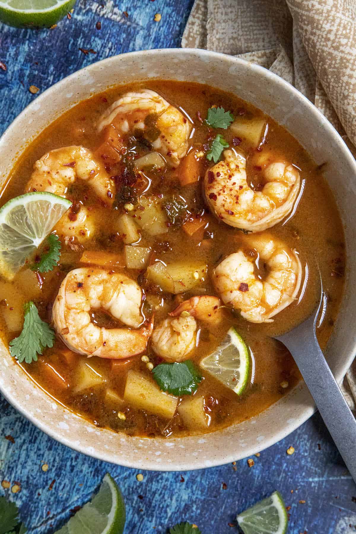 Mexican Shrimp Soup (Caldo de Camaron) in a bowl with lime and cilantro garnish