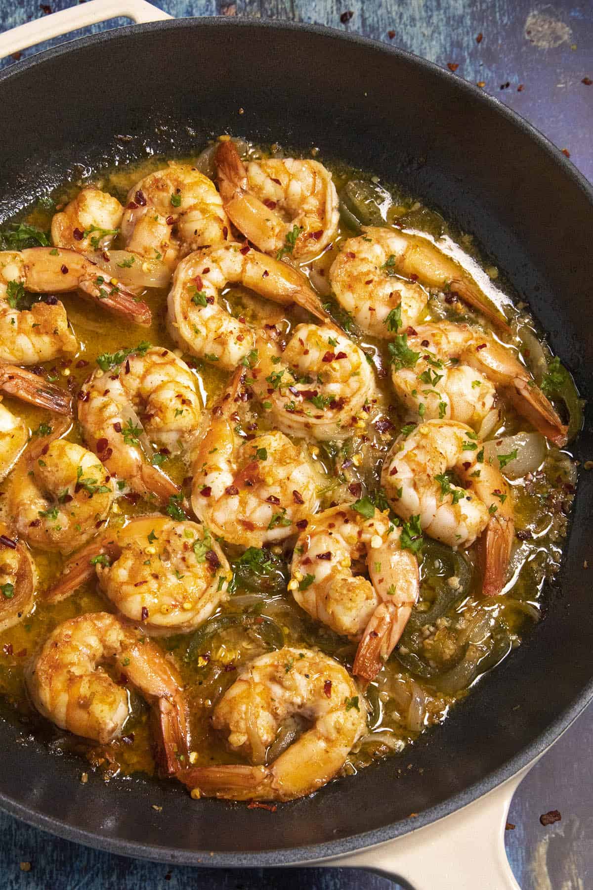 Camarones al Moj de Ajo (Mexican Garlic Shrimp) in a pan with lots of seasoned butter sauce