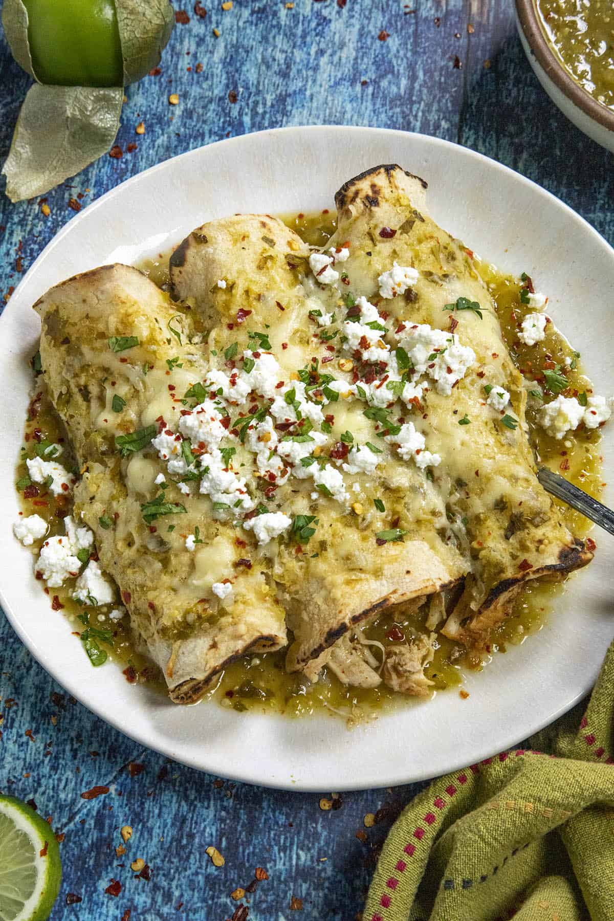 Chicken Enchiladas Verde served on a plate with crumbled white cheese