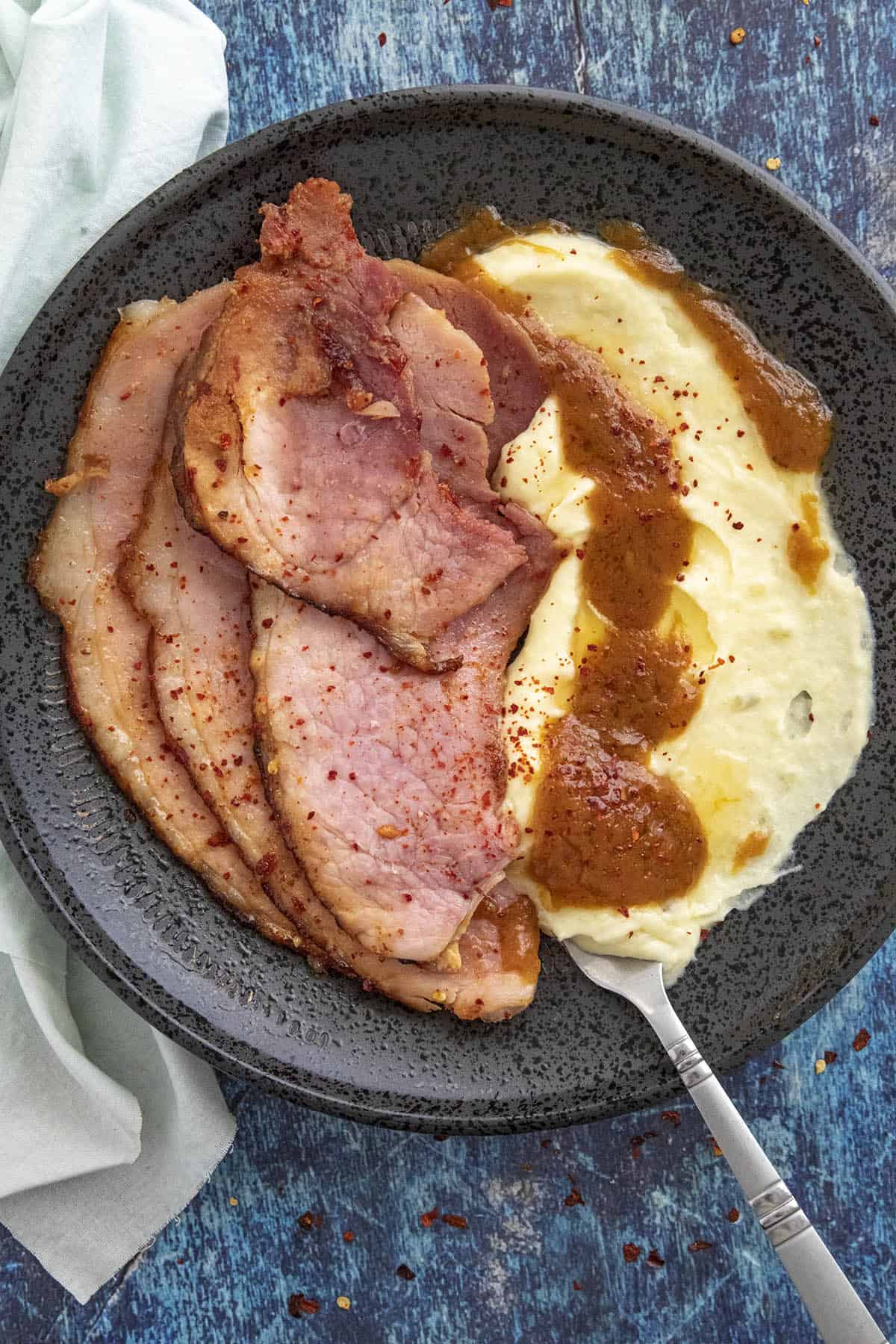 Slices Hot Honey Glazed Ham served with mashed potatoes