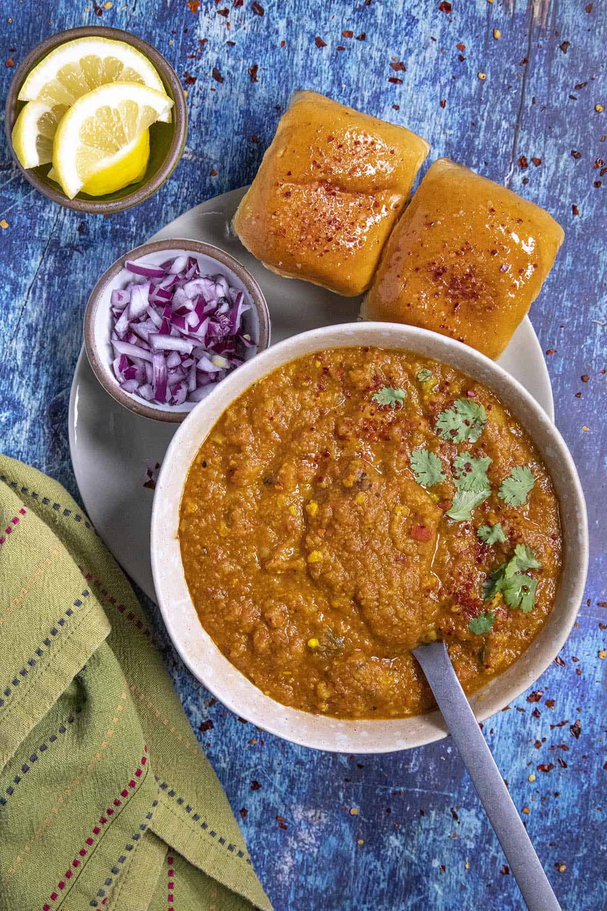 Pav Bhaji in a bowl with a cilantro garnish