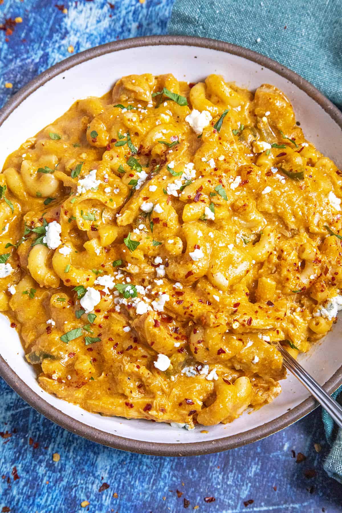 Buffalo Chicken Mac and Cheese served in a bowl with crumbled blue cheese on top