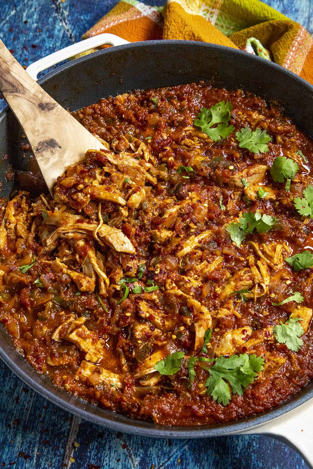Chicken Tinga in a pan with garnish