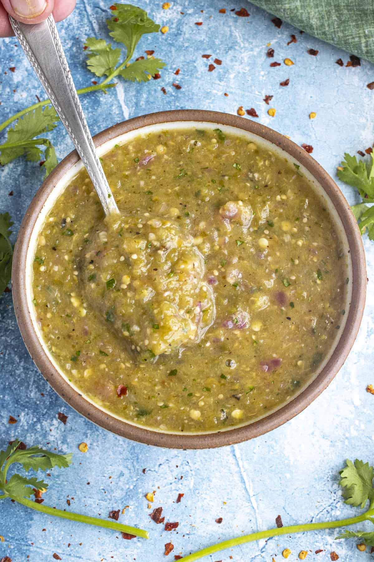 Mike taking a scoop of Creamy Tomatillo Sauce from the bowl