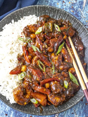 Kung Pao Shrimp served on a plate over white rice