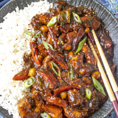 Kung Pao Shrimp served on a plate over white rice