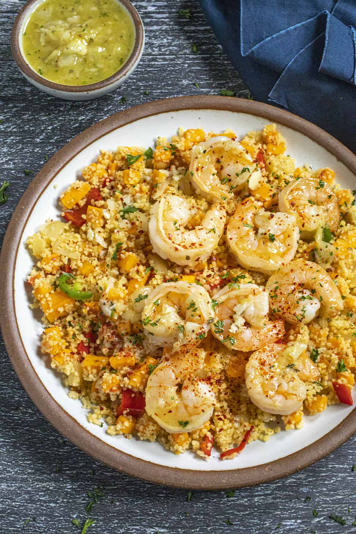 Mojo Shrimp served in a bowl over couscous loaded with chopped bell pepper and sweet potato