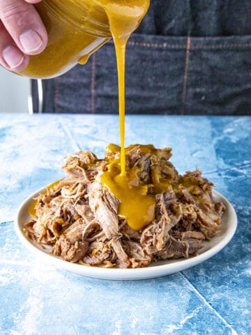 Carolina Gold Mustard BBQ Sauce poured over tender pulled pork