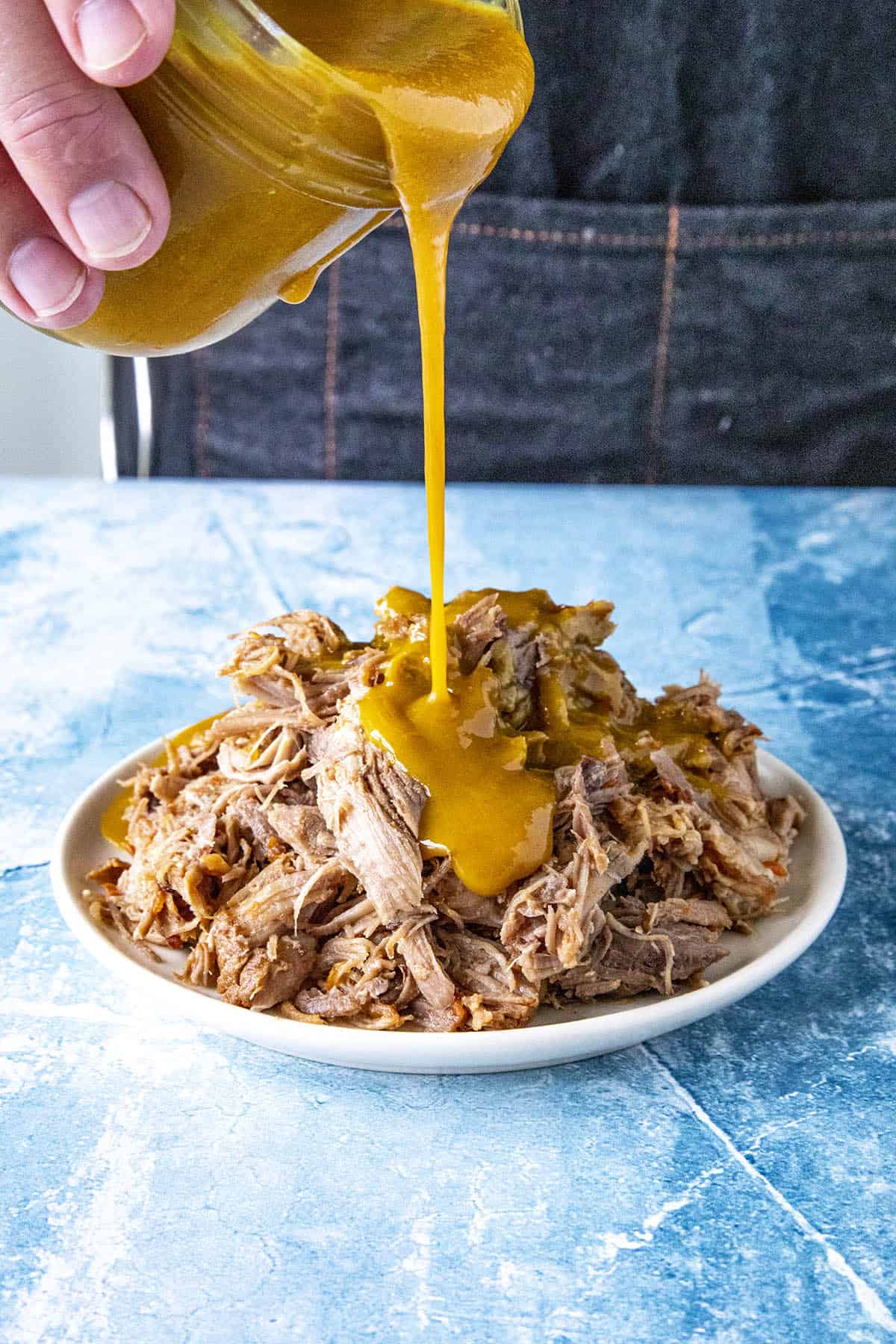 Carolina Gold Mustard BBQ Sauce poured over tender pulled pork